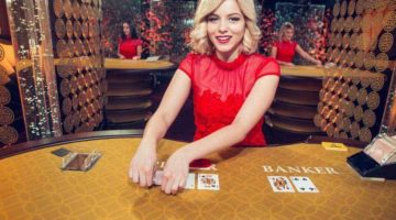 Female dealer squeezing baccarat cards.