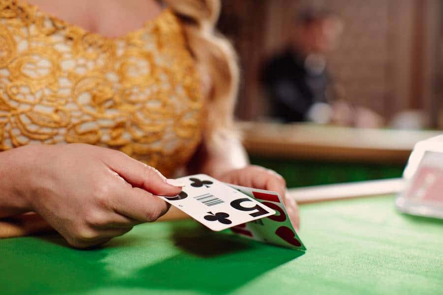 Dealer flipping cards on table.