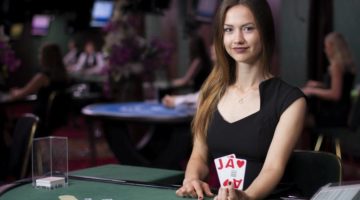 Dealer holds up 2 cards to show insurance bets.