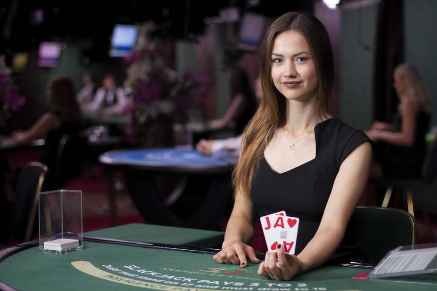 Dealer holds up 2 cards to show insurance bets.