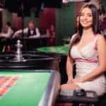 Roulette dealer sitting at table