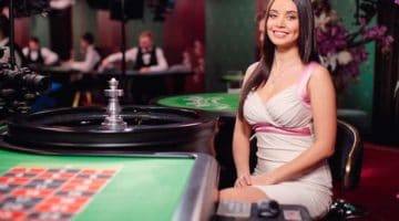 Roulette dealer sitting at table