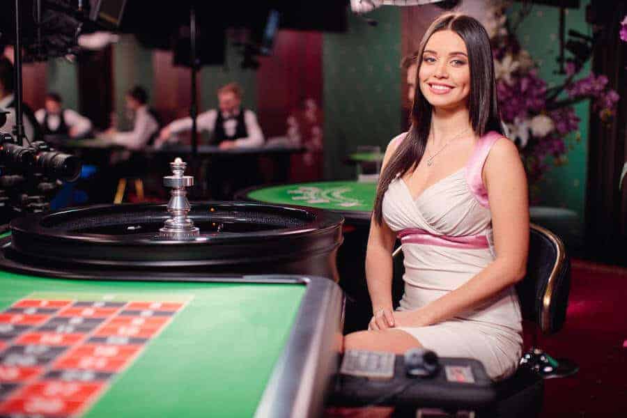 Roulette dealer sitting at table