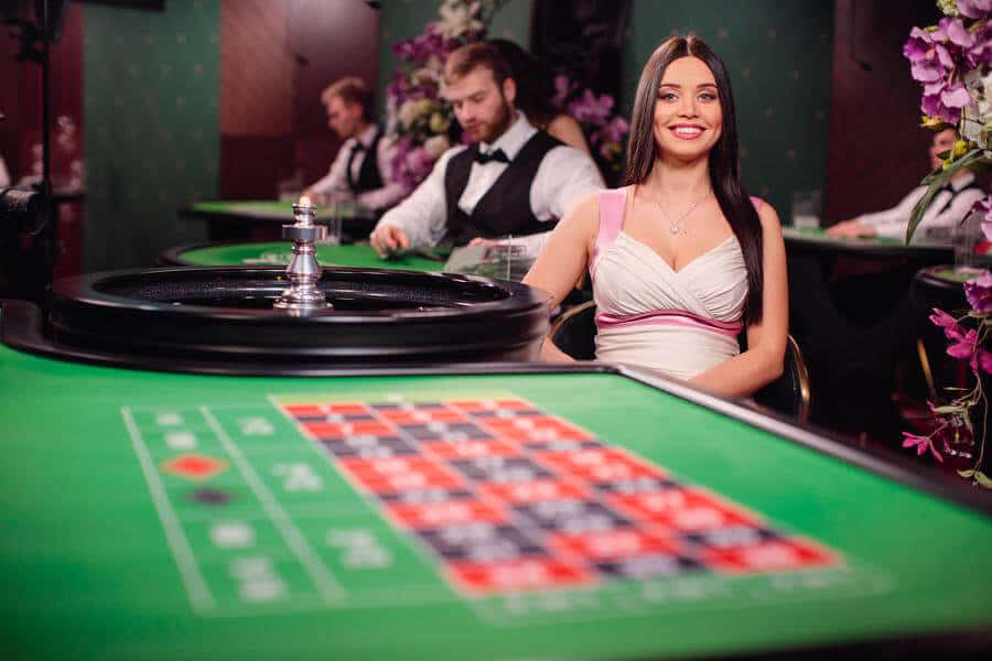 Female roulette dealer smiling