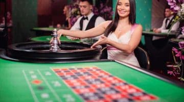 Immersive roulette dealer pointing at table