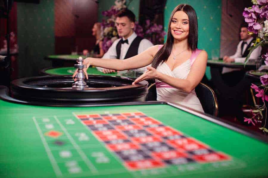Immersive roulette dealer pointing at table